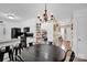 Open-concept dining room with elegant lighting, adjacent to the modern kitchen and pantry area at 4121 Dover St, Claremont, NC 28610
