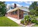 The home features a brick exterior, a two-car garage, and a beautiful flower garden at 4121 Dover St, Claremont, NC 28610