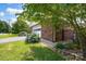 Landscaped side yard next to the brick home with blooming hydrangea at 4121 Dover St, Claremont, NC 28610