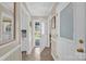 Inviting hallway featuring tile flooring, neutral walls, and access to various rooms and the backyard at 4121 Dover St, Claremont, NC 28610