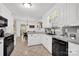 Bright kitchen with stainless steel appliances, granite countertops, and views to the dining area at 4121 Dover St, Claremont, NC 28610