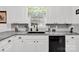 Modern kitchen with stainless steel appliances, granite countertops, and tile backsplash at 4121 Dover St, Claremont, NC 28610