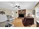 Cozy living room with brick fireplace, comfortable seating, and large windows for natural light at 4121 Dover St, Claremont, NC 28610