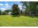 Large yard with lush lawn and a mature tree at 4121 Dover St, Claremont, NC 28610