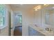 Bright bathroom featuring double vanity, modern fixtures, and a view to an adjacent room at 5511 Milhaven Ln, Charlotte, NC 28269