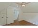 Bedroom with wood floors and view to a walk-in closet at 5511 Milhaven Ln, Charlotte, NC 28269