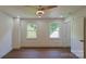 Neutral bedroom with hardwood floors, two windows, and a ceiling fan at 5511 Milhaven Ln, Charlotte, NC 28269