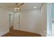 Bedroom with hardwood floors and view to an adjoining room at 5511 Milhaven Ln, Charlotte, NC 28269