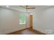 Bedroom with hardwood floors, ceiling fan and attached bathroom at 5511 Milhaven Ln, Charlotte, NC 28269