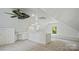 Bright, airy bonus room with carpet, windows, built-in bench, and a half-wall overlooking the space at 5511 Milhaven Ln, Charlotte, NC 28269