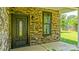 Inviting front entry with a decorative door, stone accents, and ample natural light at 5511 Milhaven Ln, Charlotte, NC 28269