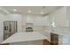 Bright kitchen featuring white cabinets, stainless steel appliances, and a large center island at 5511 Milhaven Ln, Charlotte, NC 28269