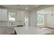 Bright kitchen featuring white cabinets, stainless steel appliances, and a large center island at 5511 Milhaven Ln, Charlotte, NC 28269