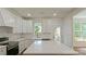 Bright kitchen featuring white cabinets, stainless steel appliances, and a large center island at 5511 Milhaven Ln, Charlotte, NC 28269