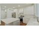 Bright kitchen featuring white cabinets, stainless steel appliances, and a large center island at 5511 Milhaven Ln, Charlotte, NC 28269
