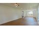 Spacious living room with hardwood floors and large windows, showcasing an open concept layout at 5511 Milhaven Ln, Charlotte, NC 28269