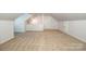 Expansive attic space with neutral carpeting, offering versatile potential at 7039 Executive Cir, Denver, NC 28037