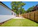 Green backyard featuring a stone patio with seating and a wooden privacy fence at 7039 Executive Cir, Denver, NC 28037