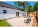 Backyard featuring a stone patio with seating next to the white home's back entrance at 7039 Executive Cir, Denver, NC 28037