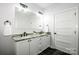 Bright bathroom featuring a double vanity with granite countertops and modern fixtures at 7039 Executive Cir, Denver, NC 28037