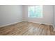 Bright bedroom with wood-look flooring and a window at 7039 Executive Cir, Denver, NC 28037