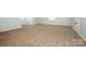 Spacious bedroom features neutral carpeting and natural light from a window at 7039 Executive Cir, Denver, NC 28037