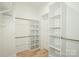 Walk-in closet with custom shelving and rod fixtures for optimal storage solutions at 7039 Executive Cir, Denver, NC 28037