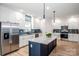 Modern kitchen with stainless steel appliances, island, and ample cabinet space at 7039 Executive Cir, Denver, NC 28037