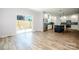 Open living space with hardwood floors, sliding glass door, and bright kitchen at 7039 Executive Cir, Denver, NC 28037