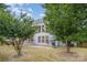 Picturesque backyard featuring mature trees, a grilling area, patio space and manicured lawn at 7623 Rathburn Ln, Charlotte, NC 28277