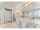 Primary bathroom featuring double vanity, tub and shower, white cabinets and tile flooring at 7623 Rathburn Ln, Charlotte, NC 28277