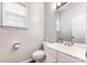 Half bathroom featuring a bright window, a large mirror, and a white vanity at 7623 Rathburn Ln, Charlotte, NC 28277