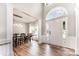 Welcoming foyer with grand entry, chandelier, hardwood floors, and adjacent formal dining room with a large window at 7623 Rathburn Ln, Charlotte, NC 28277