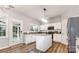 Bright kitchen with granite countertops, a central island, white cabinets, and stainless steel appliances at 7623 Rathburn Ln, Charlotte, NC 28277