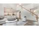 Bright living room featuring an open-concept design, hardwood floors, and modern furniture at 7623 Rathburn Ln, Charlotte, NC 28277