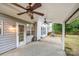 Covered outdoor patio with dual ceiling fans and a grilling area, perfect for entertaining at 7623 Rathburn Ln, Charlotte, NC 28277