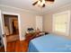 Bedroom featuring hardwood floors, soft blue bedding, and natural light from the window at 792 W Nc Hwy 150 St, Lincolnton, NC 28092