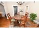 Dining room features hardwood floors, chandelier, round table with four chairs, and natural light at 792 W Nc Hwy 150 St, Lincolnton, NC 28092