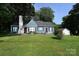 Quaint blue home with manicured lawn, chimney, black shutters, and red front door at 792 W Nc Hwy 150 St, Lincolnton, NC 28092