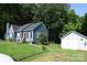 Charming blue home with a red front door, manicured lawn, and detached garage at 792 W Nc Hwy 150 St, Lincolnton, NC 28092