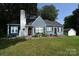 Charming blue single-Gathering home with white-painted brick, red door, and beautiful landscaping at 792 W Nc Hwy 150 St, Lincolnton, NC 28092