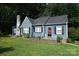 Charming blue single-Gathering home with a red door, black shutters, and a well-manicured lawn at 792 W Nc Hwy 150 St, Lincolnton, NC 28092