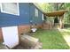 Blue home with brick foundation, utility door, and covered porch area with stairs to deck at 792 W Nc Hwy 150 St, Lincolnton, NC 28092