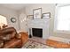 Cozy living room featuring a white fireplace with a brick hearth and hardwood floors at 792 W Nc Hwy 150 St, Lincolnton, NC 28092