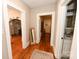 Hallway with hardwood floors leads to the living room and bathroom, showcasing the home's layout at 792 W Nc Hwy 150 St, Lincolnton, NC 28092