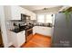 Bright kitchen features stainless steel appliances, white cabinets, granite counters, and hardwood floors at 792 W Nc Hwy 150 St, Lincolnton, NC 28092