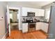 Modern kitchen featuring white cabinets, stainless steel appliances, black granite countertops and a mosaic tile backsplash at 792 W Nc Hwy 150 St, Lincolnton, NC 28092