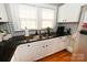 Bright kitchen features stainless steel appliances, white cabinets, granite counters, double sinks, and hardwood floors at 792 W Nc Hwy 150 St, Lincolnton, NC 28092