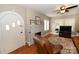 Cozy living room featuring a fireplace, ceiling fan, hardwood floors and an arched doorway at 792 W Nc Hwy 150 St, Lincolnton, NC 28092