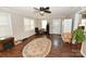 Cozy living room with wood floors, fireplace, ceiling fan, and lots of natural light at 792 W Nc Hwy 150 St, Lincolnton, NC 28092
